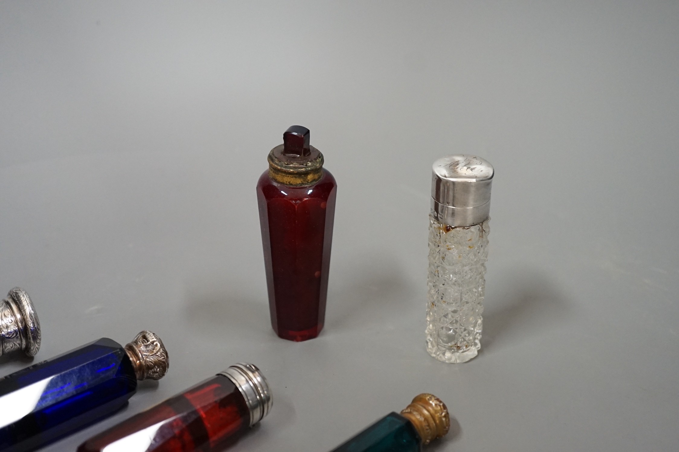 A collection of 19th century coloured and clear glass scent bottles, some silver mounted (6)